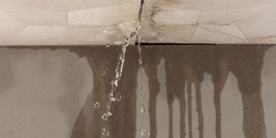 Water leaking from a ceiling causing stains.