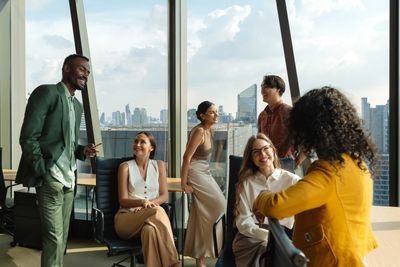 Group of people at work with a sky view in the background.