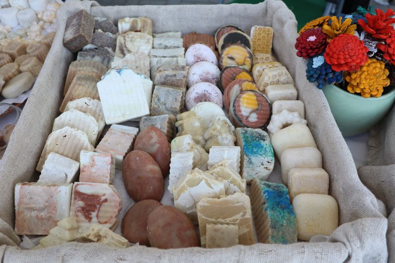 A vibrant and eyecatching showcase of artisan handmade soaps that are arranged beautifully and creatively for sale