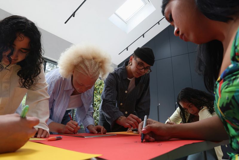 Diverse people working together on creative project around table