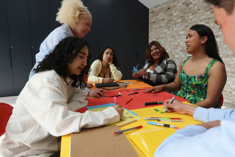 Diverse people working together on creative project around table