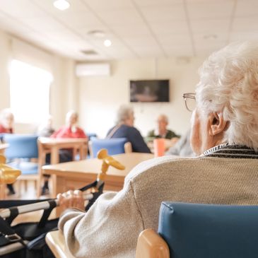 Group of elderly sitting in chairs