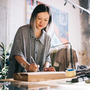 Woman focused on her painting project at a table.