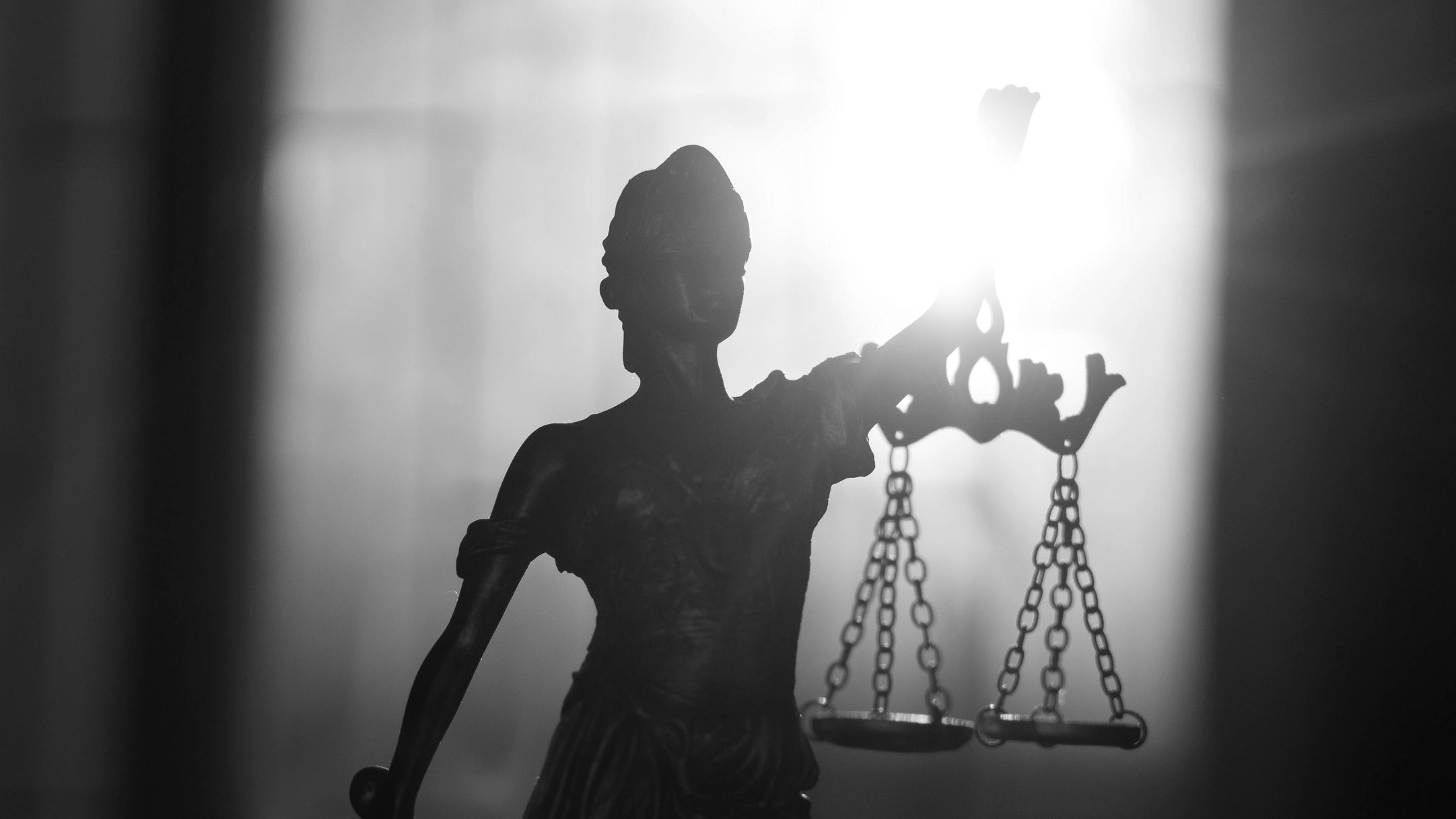 North Carolina Center for Women's Justice (NCCWJ) silhouette of Lady Justice holding scales of justi