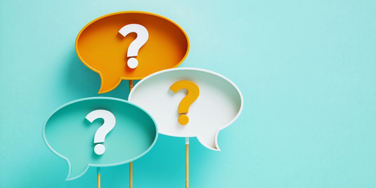 Colorful speech bubbles with question marks on a blue background.