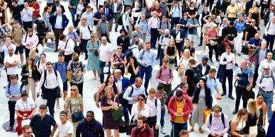 Crowd of diverse people crossing a street.