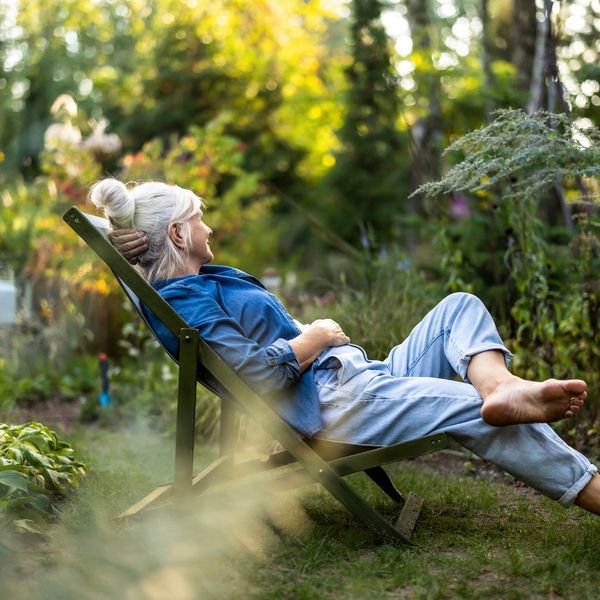 old lady relaxing in a chair outside