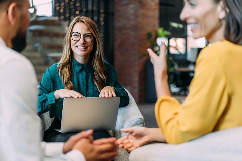Shot of group of business persons in business meeting. Three entrepreneurs on meeting in board room. Creative business team on meeting in modern office. Female manager discussing new project with her colleagues. Company owner on a meeting with two of her employees in her office.