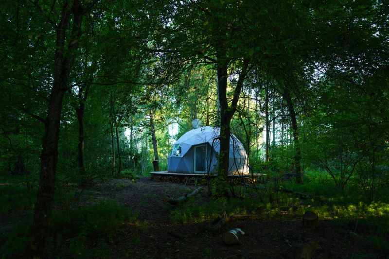 Glamping Domes in campsite in forest. Geodesic Dome House. Glamping Home for relax and yoga. Camping in Glamping park. FDomes geodesic, geodome tent in nature. Luxury Dome tent in camping. Adventure