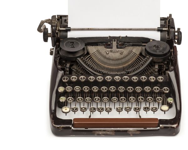 Vintage typewriter with blank sheet of paper inserted.