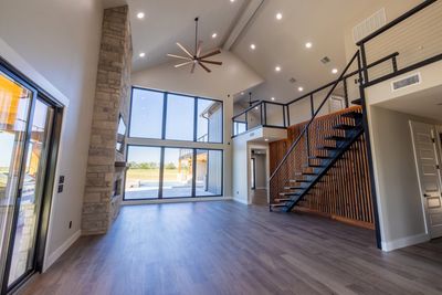 Minimalist staircase featuring black steel stringers and sleek wooden steps in Ft Lauderdale, Fl