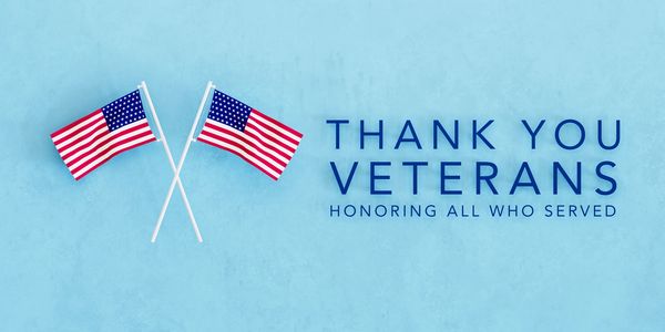 Two crossed American flags with a thank you message for veterans.