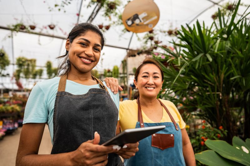Portrait of coworkers using digital tablet at a garden center