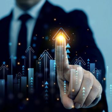 A businessman pointing at an upward arrow symbolizing growth.