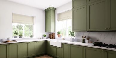 Modern kitchen with olive green cabinets and large windows.