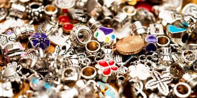 Close-up of colorful and silver assorted jewelry charms.