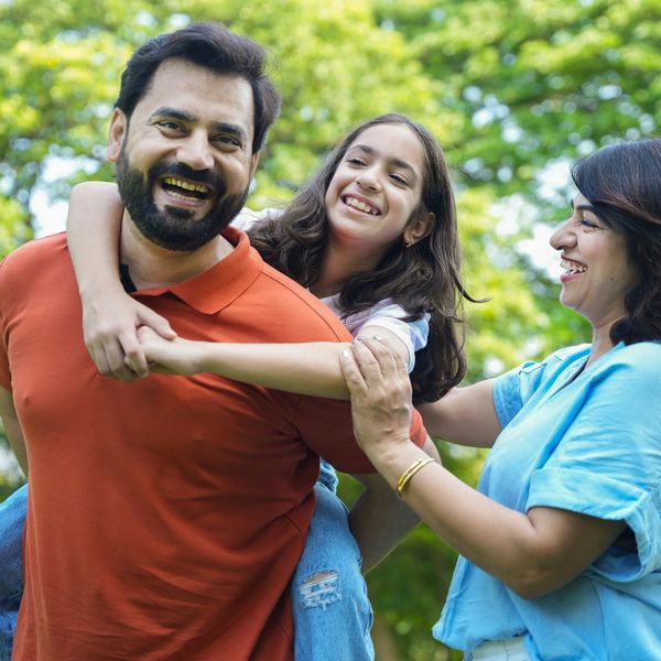 A family smiling and laughing in the garden 