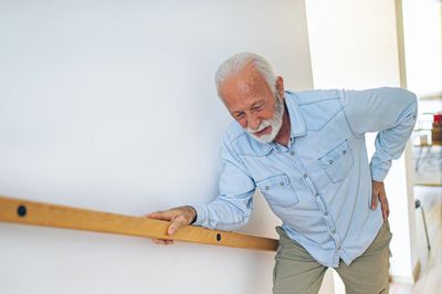 alt="man climbing stairs with arthritis"