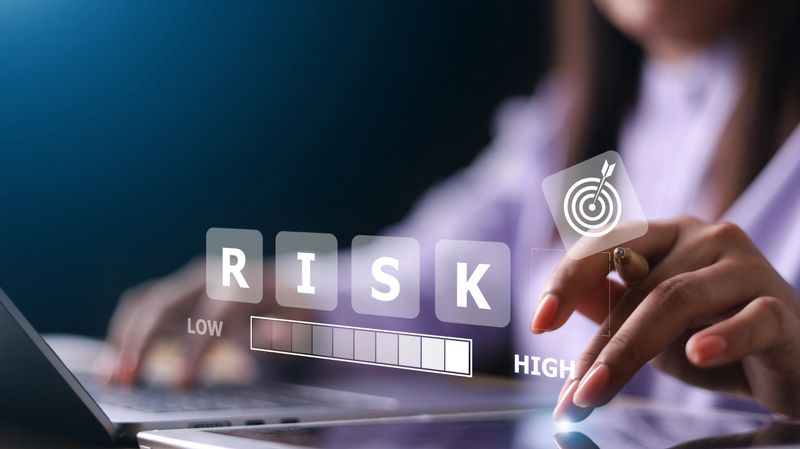 Businesswoman use laptop with Risk analysis in business decisions. Risk management concept.