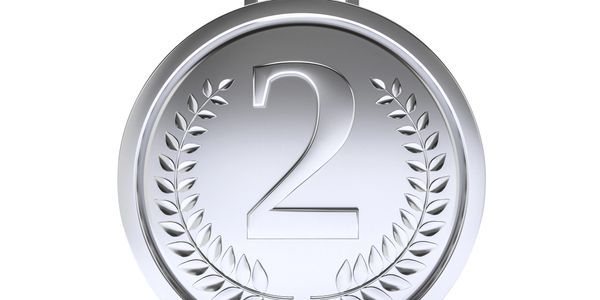 A silver medal with the number 2 and laurel leaves design.