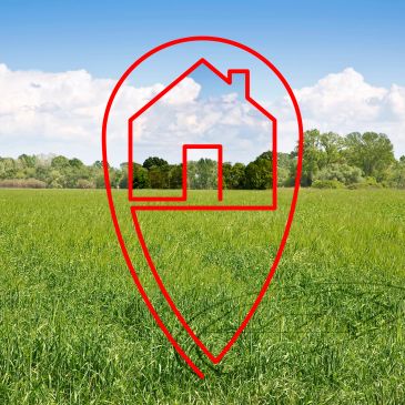 Red house location icon over green field.