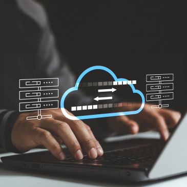 Hands typing on laptop with cloud computing icons.