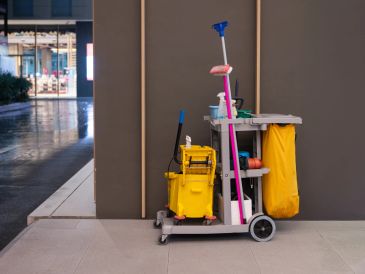 A janitor's cleaning cart with supplies.