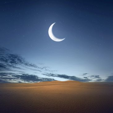 Crescent moon shining over a vast desert under a starry twilight sky.