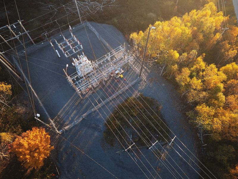 Aerial view of a small electrical substation on an October evening.
