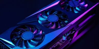 RGB-lit graphics card with triple-fan cooling in a dark PC setup.