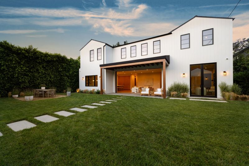 Stunning modern farmhouse design blending seamlessly with natural landscape.