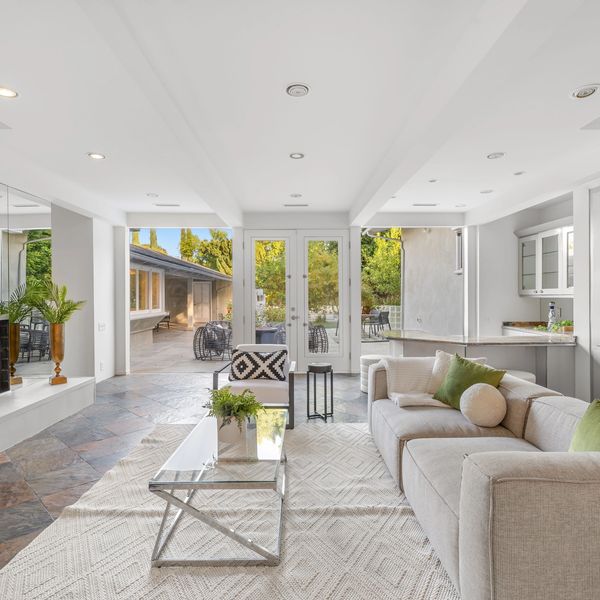 Modern living room with fireplace and outdoor patio view.