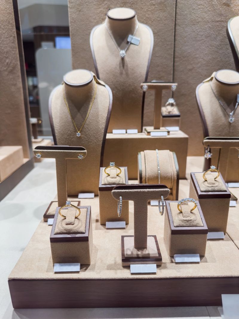 Showcase with luxury golden diamond necklaces, bracelets and earrings in a jewellery shop. Shopping concept