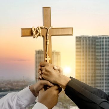 Hands holding a wooden cross with a rosary against a city skyline at sunset.
