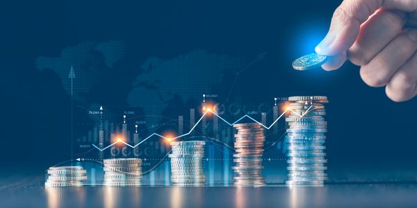 Hand stacking coins with a futuristic financial graph overlay symbolizing investment growth.