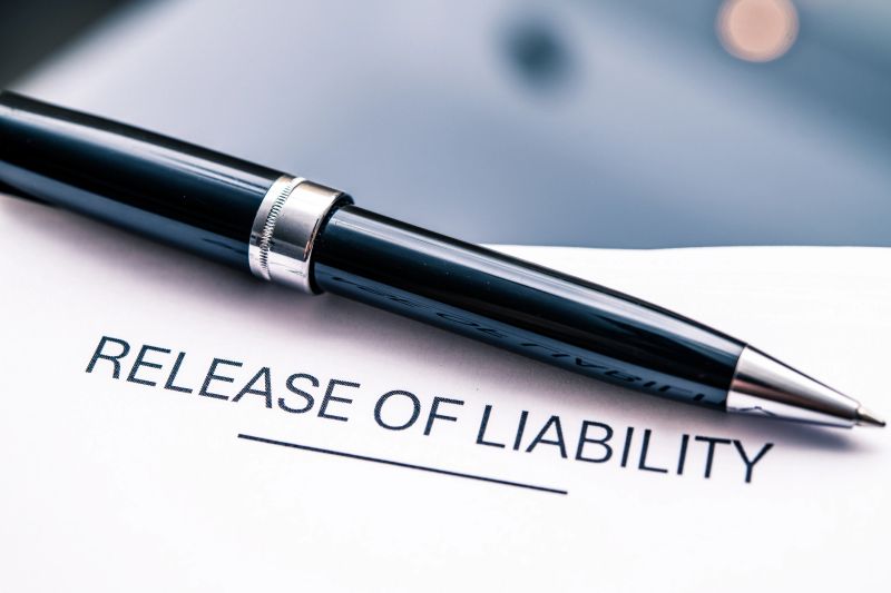Detailed focus on a liability release form paired with a stylish black pen, essential for legal agreements, contracts, and risk management in business endeavors.