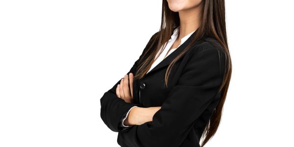 Confident woman in black blazer with arms crossed.