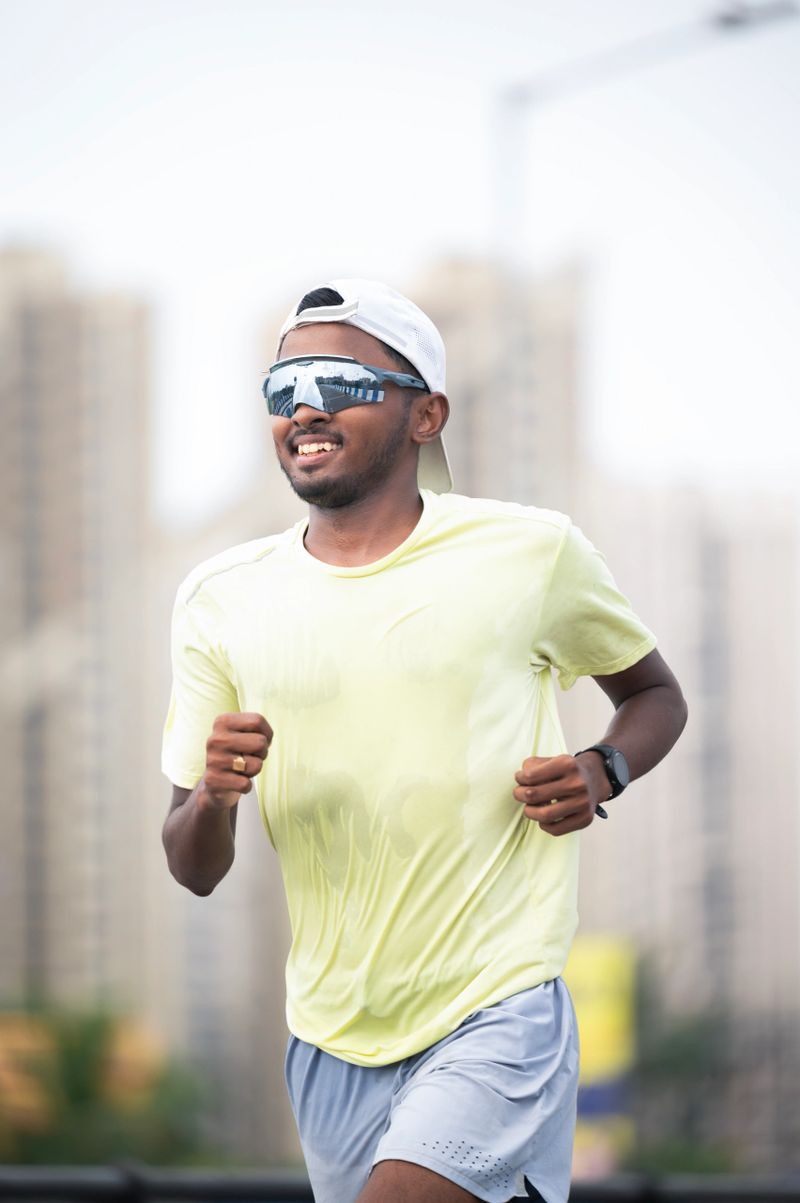 Athletic man running and getting fit in the city downtown after work