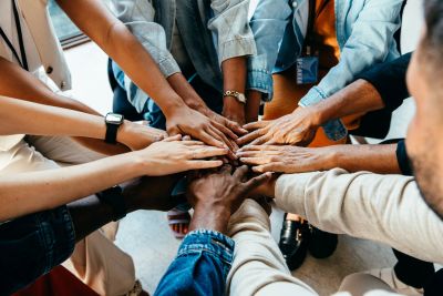 People joining hands in unity.