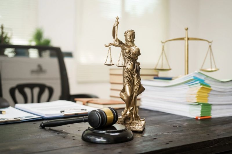A lawyer's desk in the office is filled with legal documents.The lawyer provides consultations on civil criminal law,contract management, inheritance, notary public services,temporary bail requests.