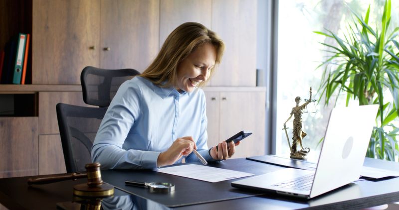 Legal consultant lawyer having a phone conversation with her client in her office.