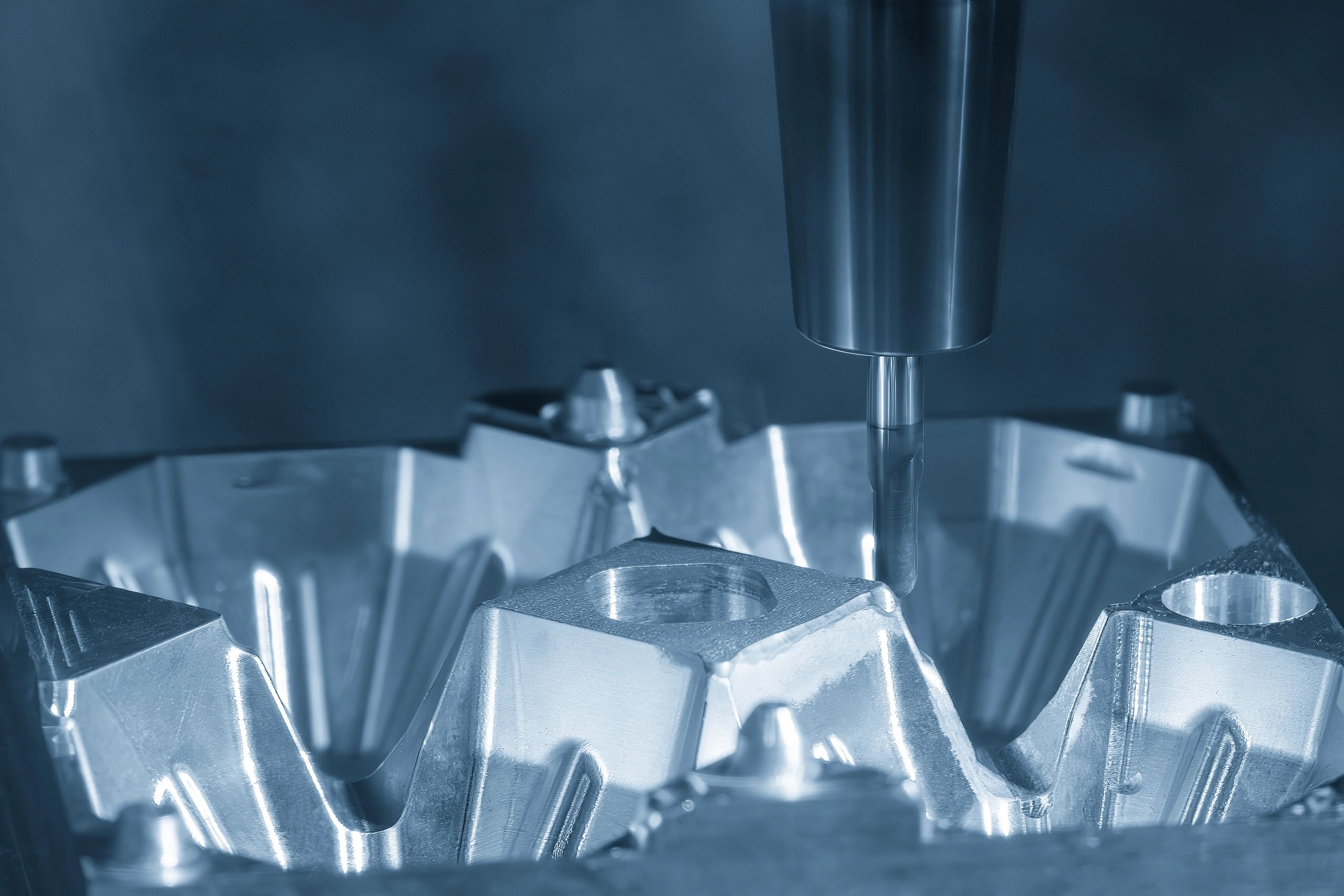 Close-up of a CNC machine tool machining a shiny metal part.