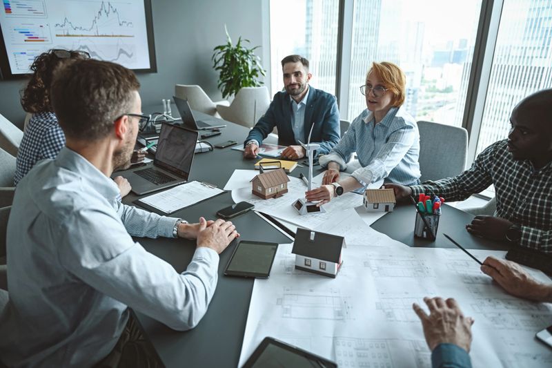 team of professionals discusses the construction of suburban housing and equipping it with alternative energy