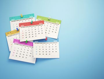 Multiple colorful July 2025 calendars pinned on a blue background.
