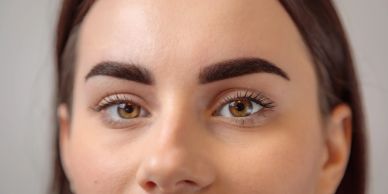 Close-up of a woman's face focusing on her eyes and eyebrows.