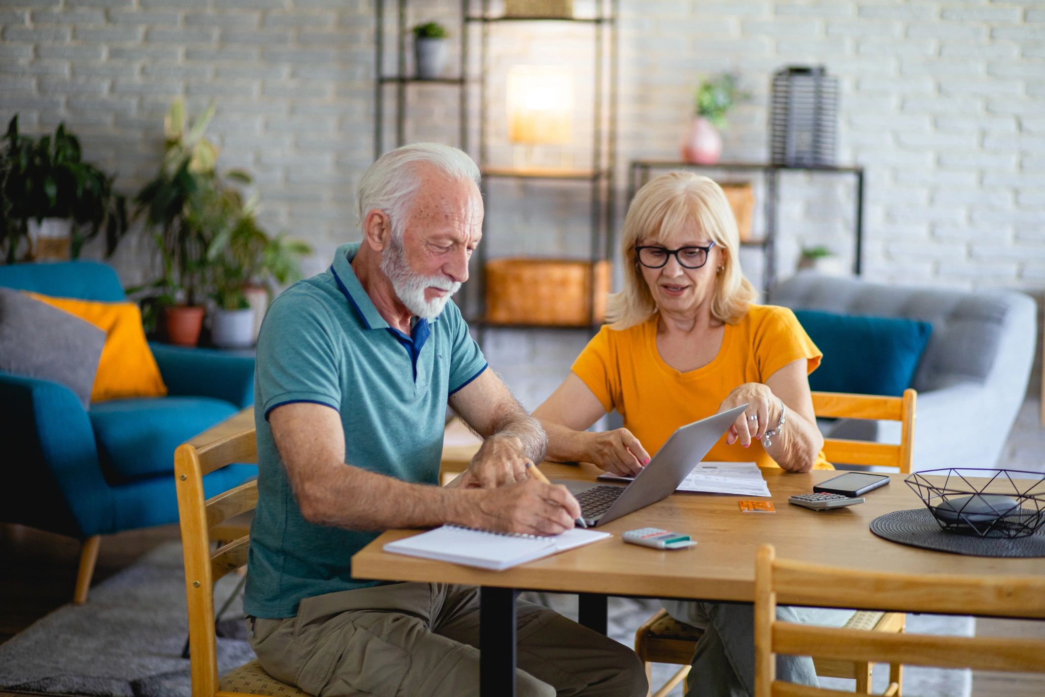 Older couple reviewing a home safety checklist together at their kitchen table