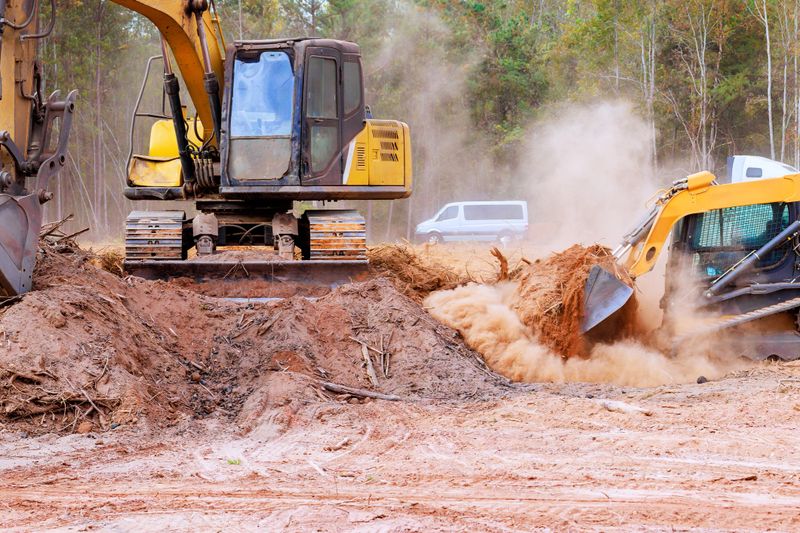 Tractor bulldozer is leveling ground earthmoving on construction site grading soil to prepare construction