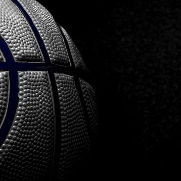 Close-up of a basketball against a dark background.