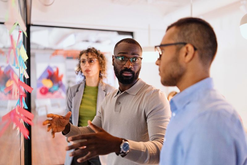 Group of modern people discussing something on a business meeting