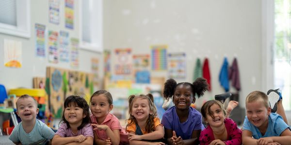 Image of a row of diverse, smiling children